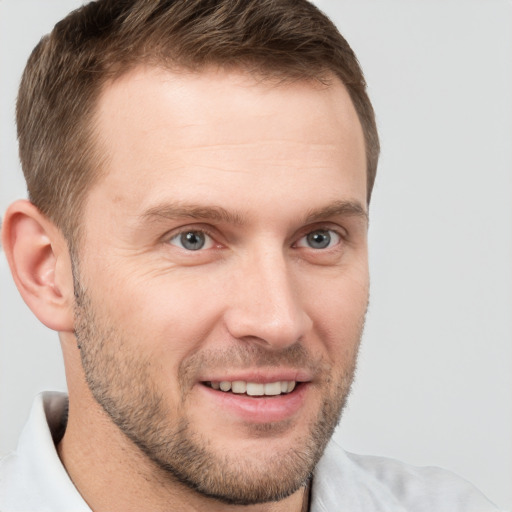 Joyful white young-adult male with short  brown hair and brown eyes