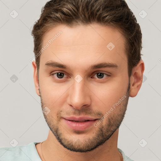 Joyful white young-adult male with short  brown hair and brown eyes