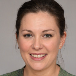 Joyful white adult female with medium  brown hair and grey eyes