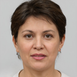 Joyful white adult female with short  brown hair and brown eyes