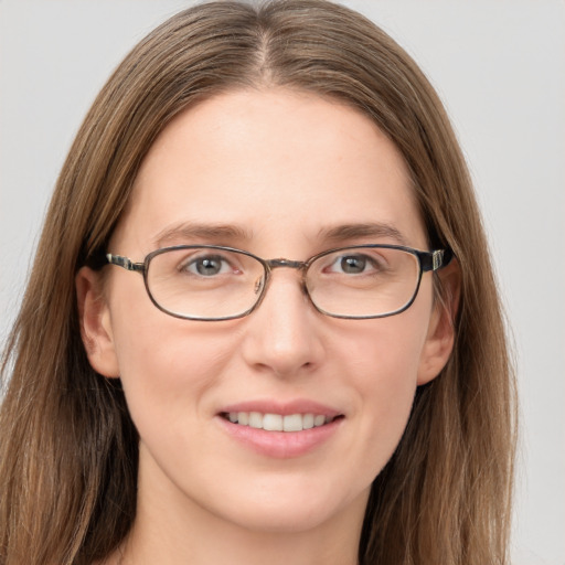 Joyful white adult female with long  brown hair and grey eyes