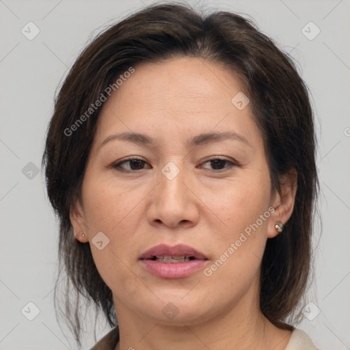 Joyful white adult female with medium  brown hair and brown eyes