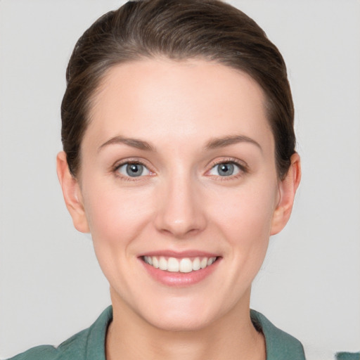 Joyful white young-adult female with short  brown hair and grey eyes