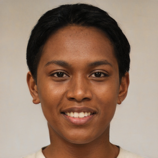 Joyful black young-adult female with short  black hair and brown eyes