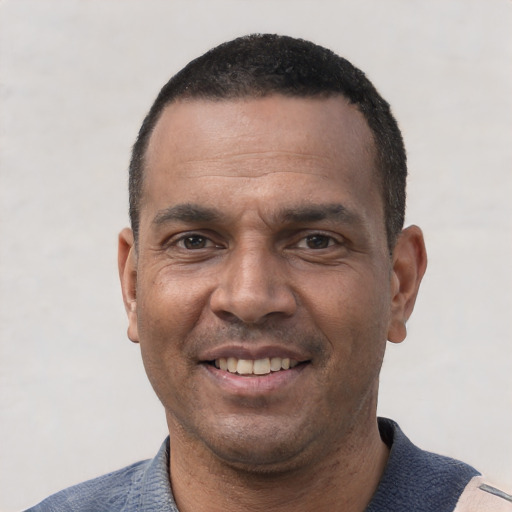 Joyful white adult male with short  black hair and brown eyes