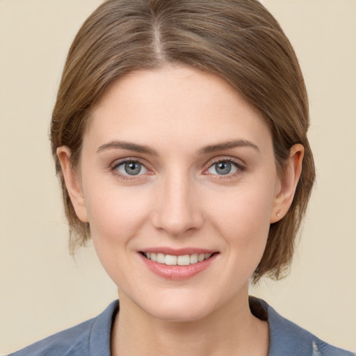 Joyful white young-adult female with medium  brown hair and grey eyes