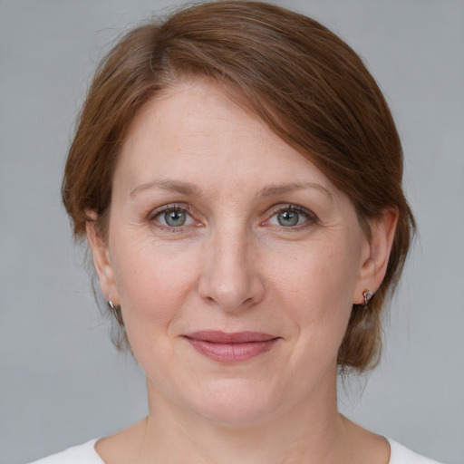 Joyful white adult female with medium  brown hair and blue eyes