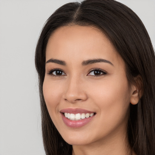 Joyful white young-adult female with long  brown hair and brown eyes