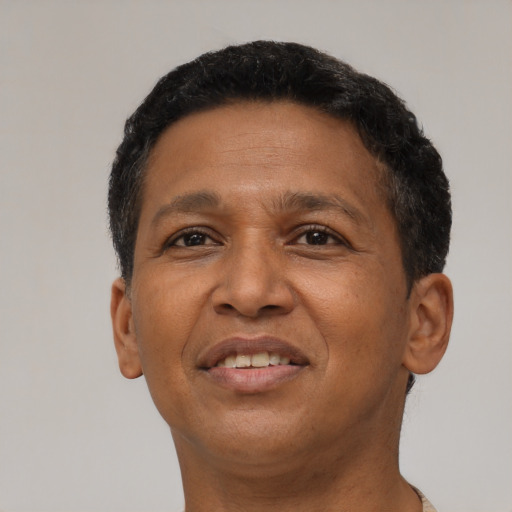 Joyful latino adult male with short  brown hair and brown eyes
