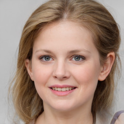 Joyful white young-adult female with medium  brown hair and blue eyes