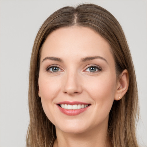 Joyful white young-adult female with long  brown hair and grey eyes