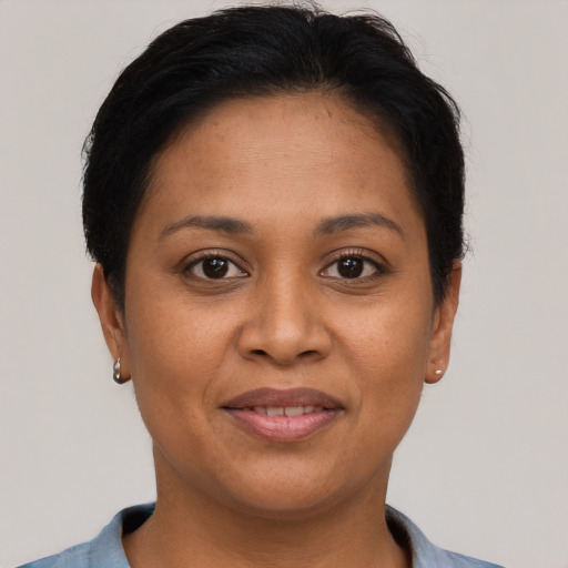 Joyful latino adult female with short  brown hair and brown eyes