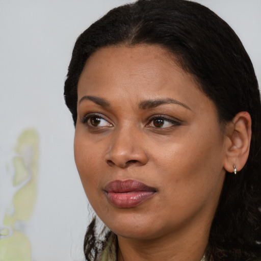 Joyful black young-adult female with medium  black hair and brown eyes