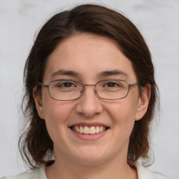 Joyful white adult female with medium  brown hair and grey eyes