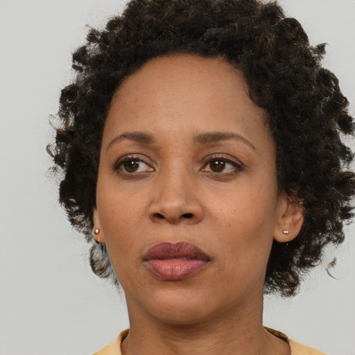 Neutral black adult female with medium  brown hair and brown eyes