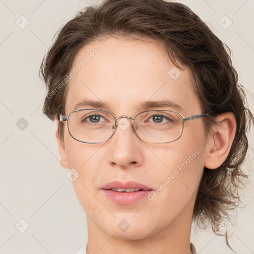 Joyful white adult female with medium  brown hair and green eyes