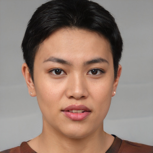 Joyful asian young-adult female with short  brown hair and brown eyes