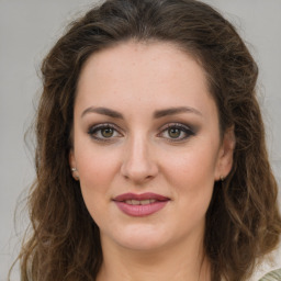 Joyful white young-adult female with long  brown hair and green eyes