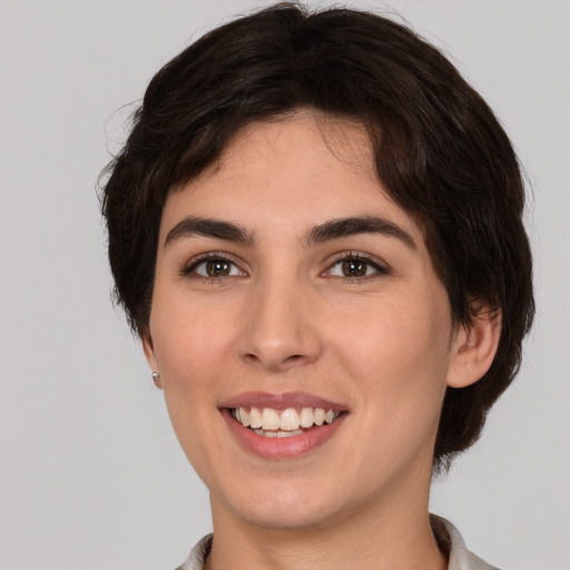 Joyful white young-adult female with medium  brown hair and brown eyes