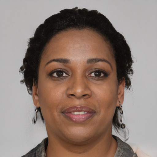Joyful black adult female with medium  black hair and brown eyes