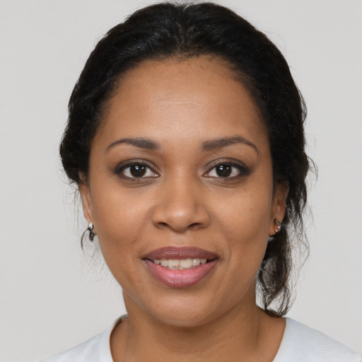 Joyful latino adult female with medium  black hair and brown eyes
