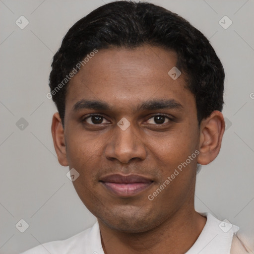 Joyful black young-adult male with short  black hair and brown eyes