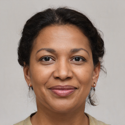 Joyful latino adult female with medium  brown hair and brown eyes