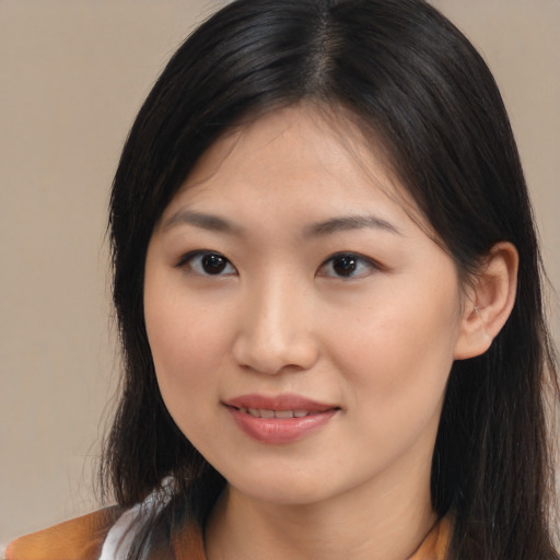 Joyful asian young-adult female with long  brown hair and brown eyes