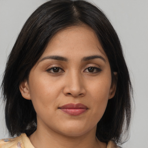 Joyful asian young-adult female with medium  brown hair and brown eyes