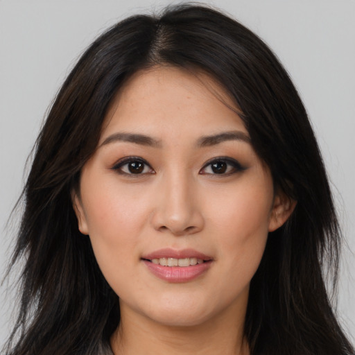 Joyful asian young-adult female with long  brown hair and brown eyes