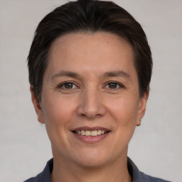 Joyful white adult female with short  brown hair and brown eyes