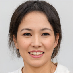 Joyful asian young-adult female with medium  brown hair and brown eyes