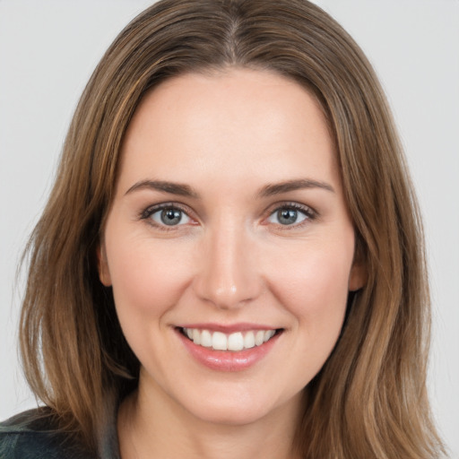 Joyful white young-adult female with long  brown hair and brown eyes