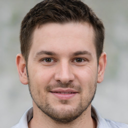 Joyful white young-adult male with short  brown hair and brown eyes