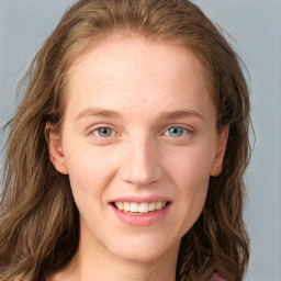 Joyful white young-adult female with long  brown hair and blue eyes