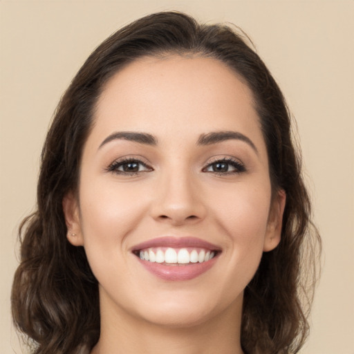 Joyful white young-adult female with long  brown hair and brown eyes