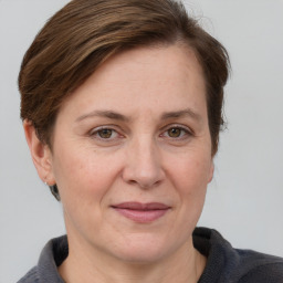 Joyful white adult female with medium  brown hair and grey eyes