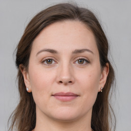 Joyful white young-adult female with long  brown hair and grey eyes