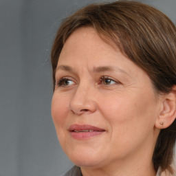 Joyful white adult female with medium  brown hair and brown eyes