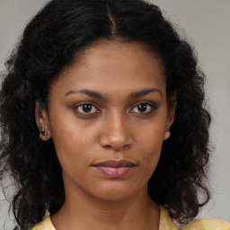 Neutral black young-adult female with long  brown hair and brown eyes