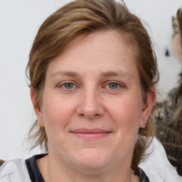 Joyful white adult female with medium  brown hair and brown eyes