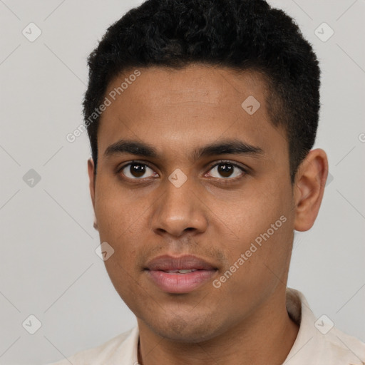 Joyful black young-adult male with short  black hair and brown eyes