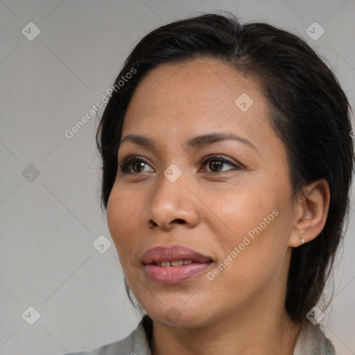 Joyful black adult female with medium  brown hair and brown eyes