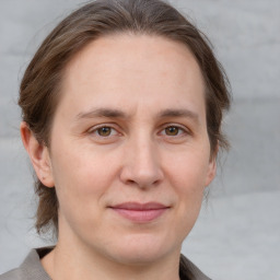 Joyful white adult female with medium  brown hair and grey eyes