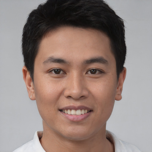 Joyful asian young-adult male with short  brown hair and brown eyes