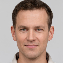 Joyful white adult male with short  brown hair and grey eyes