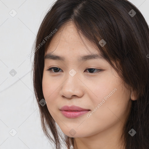 Joyful asian young-adult female with long  brown hair and brown eyes