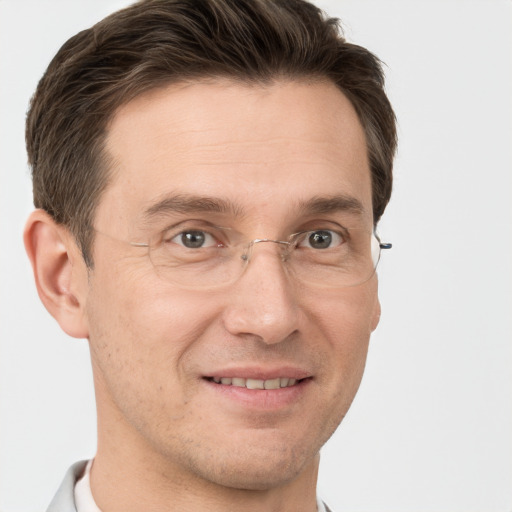 Joyful white adult male with short  brown hair and grey eyes