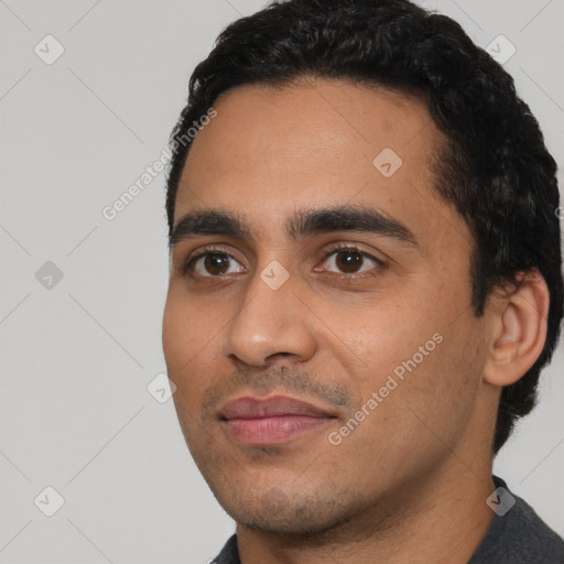 Joyful latino young-adult male with short  black hair and brown eyes