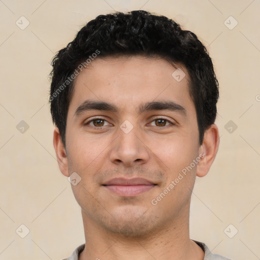 Joyful latino young-adult male with short  black hair and brown eyes